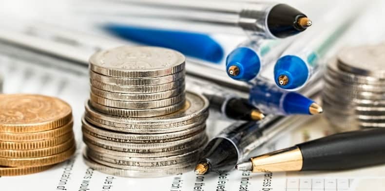 Closeup of pens and stacks of coins