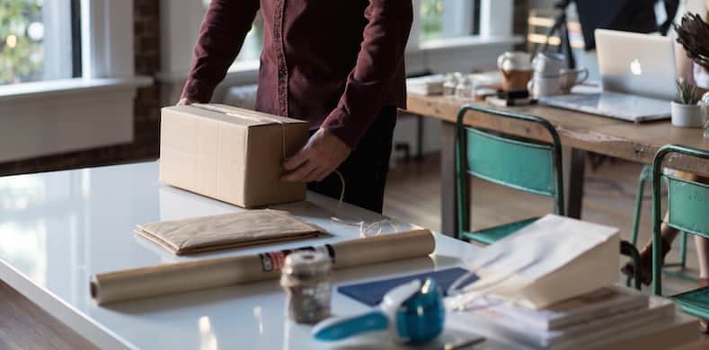 Person wrapping up product at a table