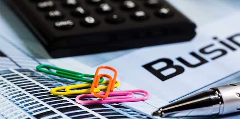 Paperclips, calculator and ballpoint pen