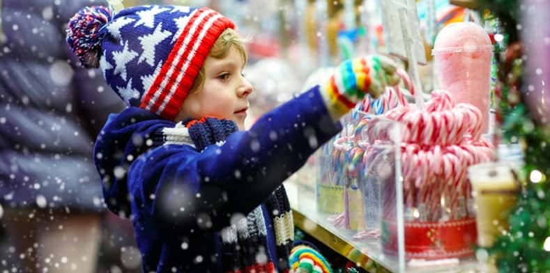 Child picks out candy at christmas market