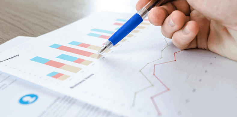 Close up of pen and accountancy graph