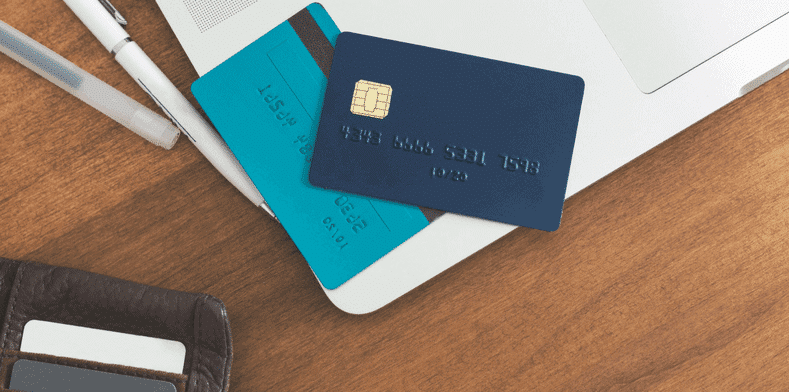 Credit cards resting on corner of a laptop
