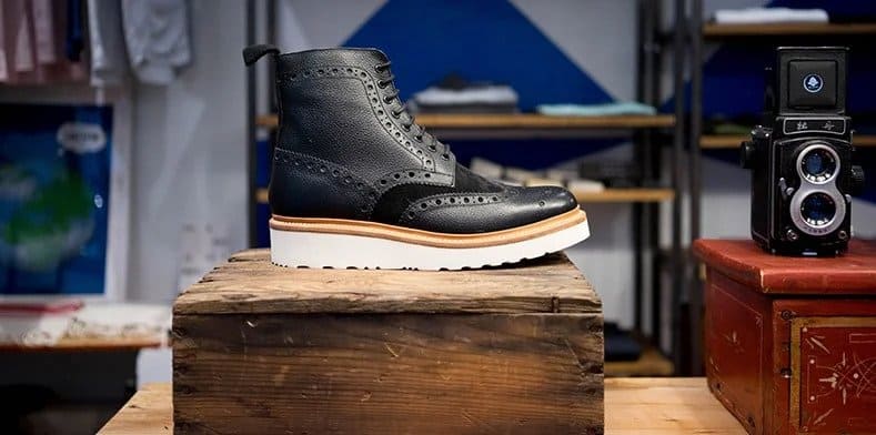 Brogue black boots on table