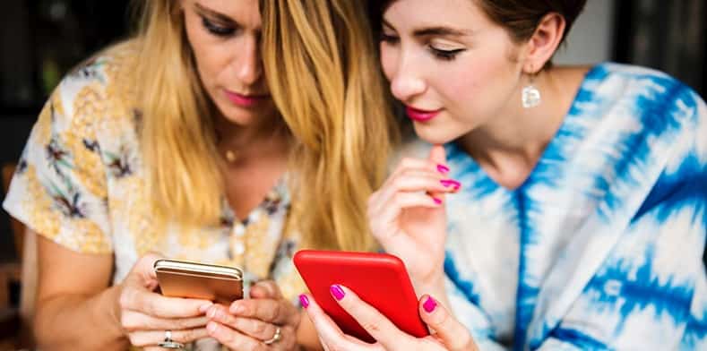 Women looking at mobile phones