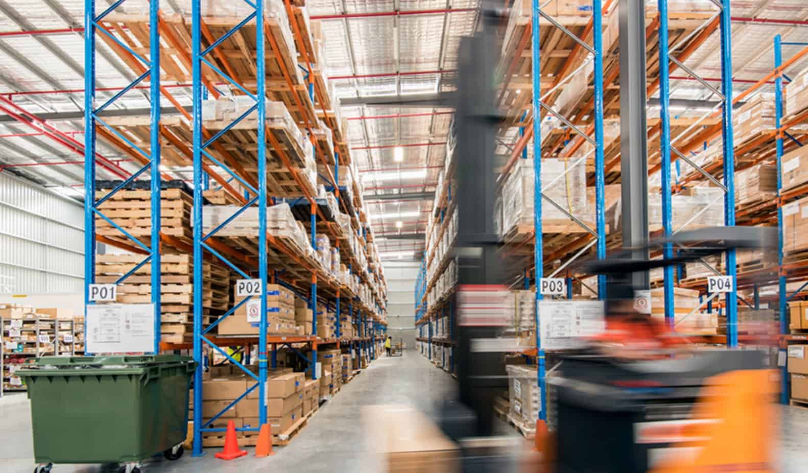 Warehouse shelves and forklift in motion