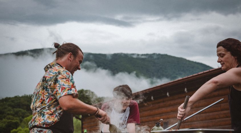 People cooking on barbeque