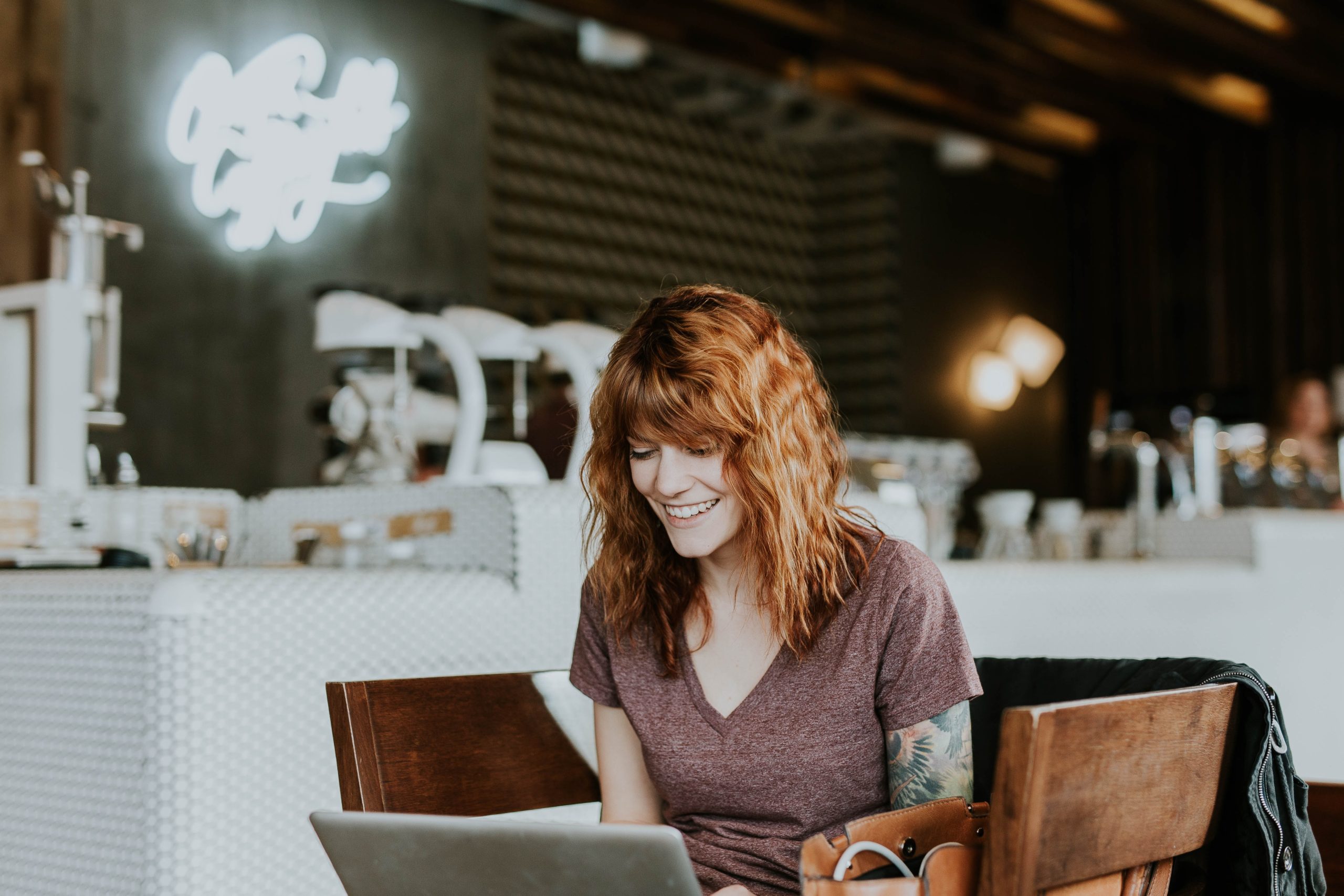 Person works on laptop in coffee shop
