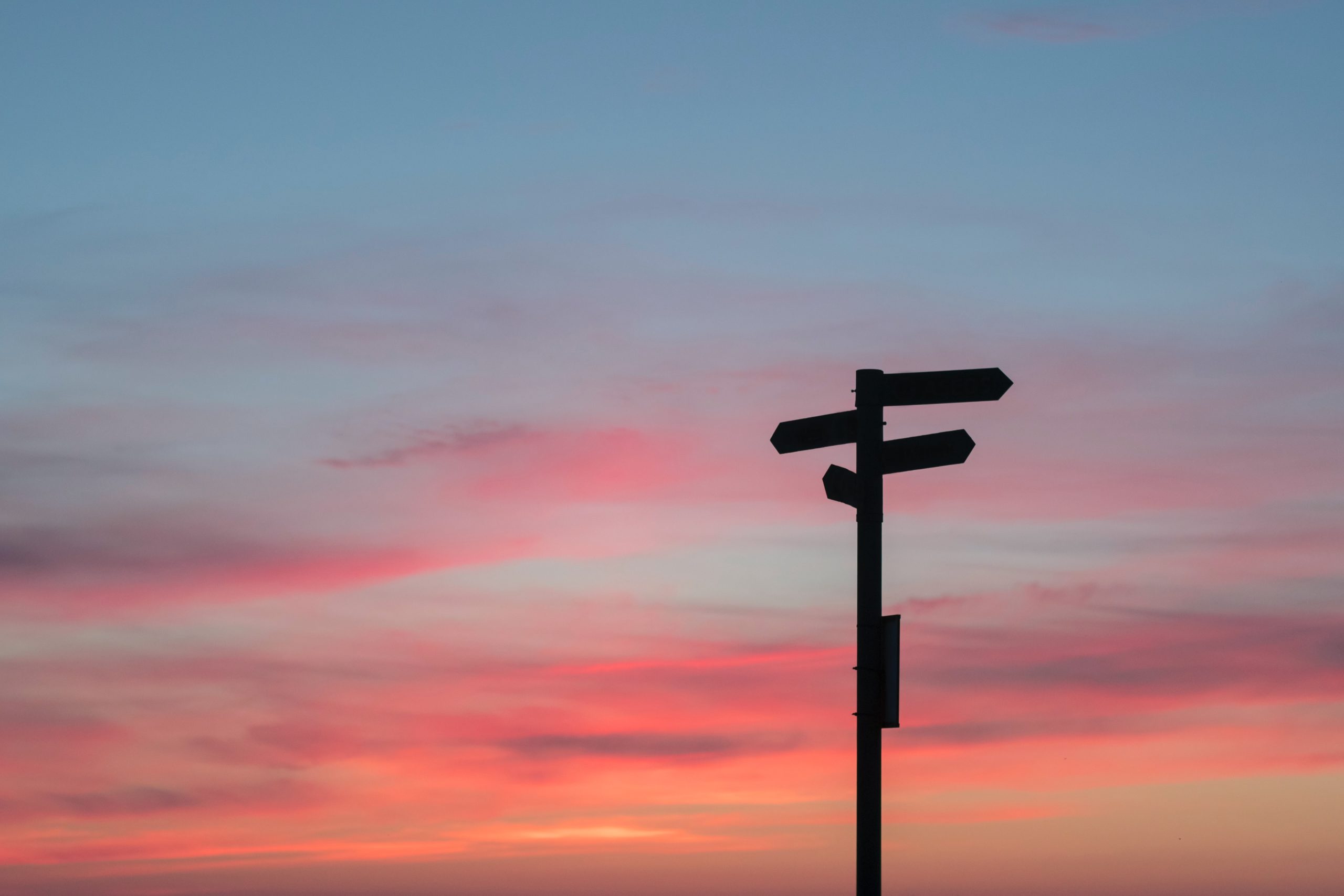 Signposts in silhouete with sunset skys in background
