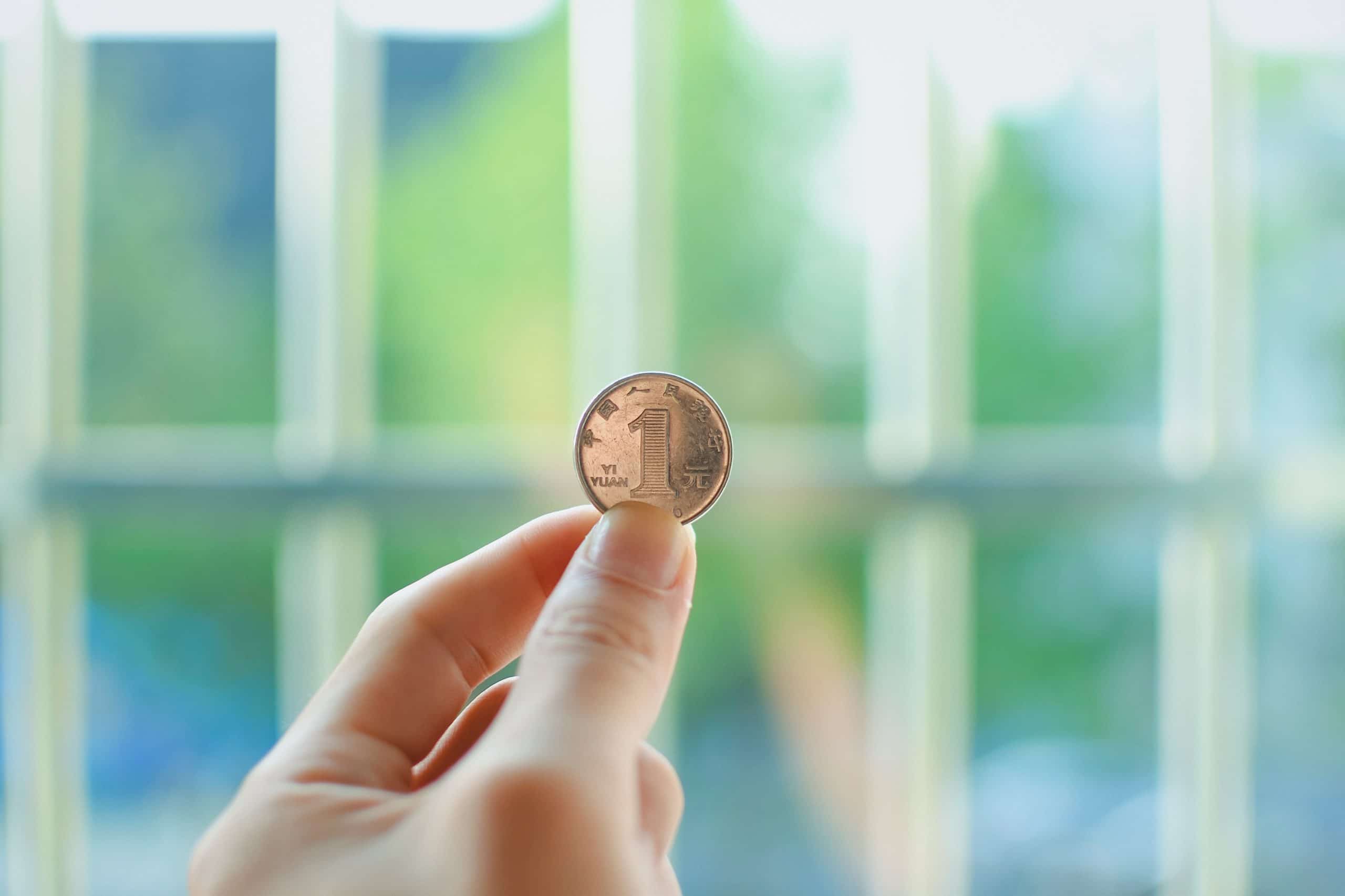 Close up of hand holding a coin