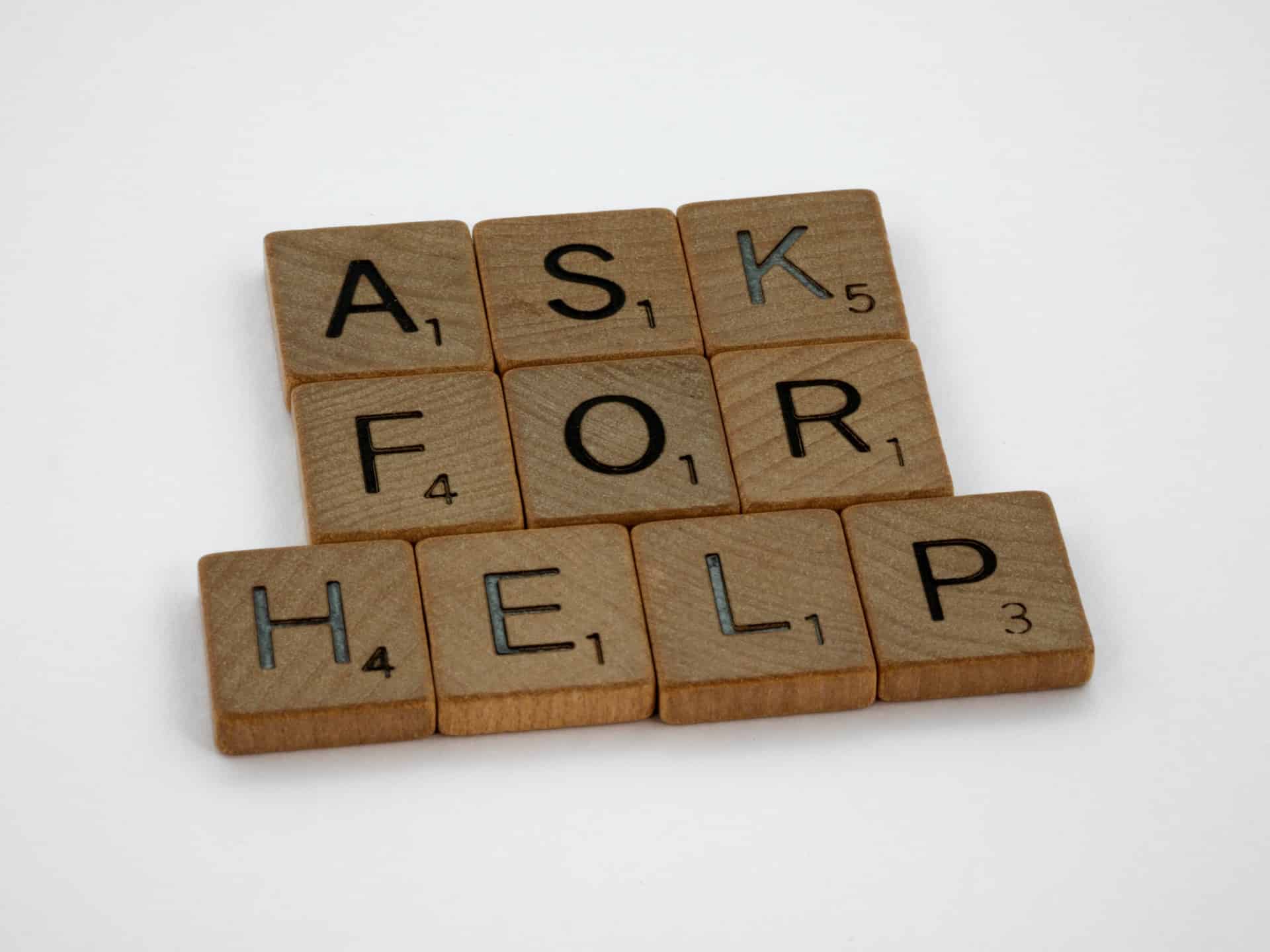 Ask for help written in scrabble bricks