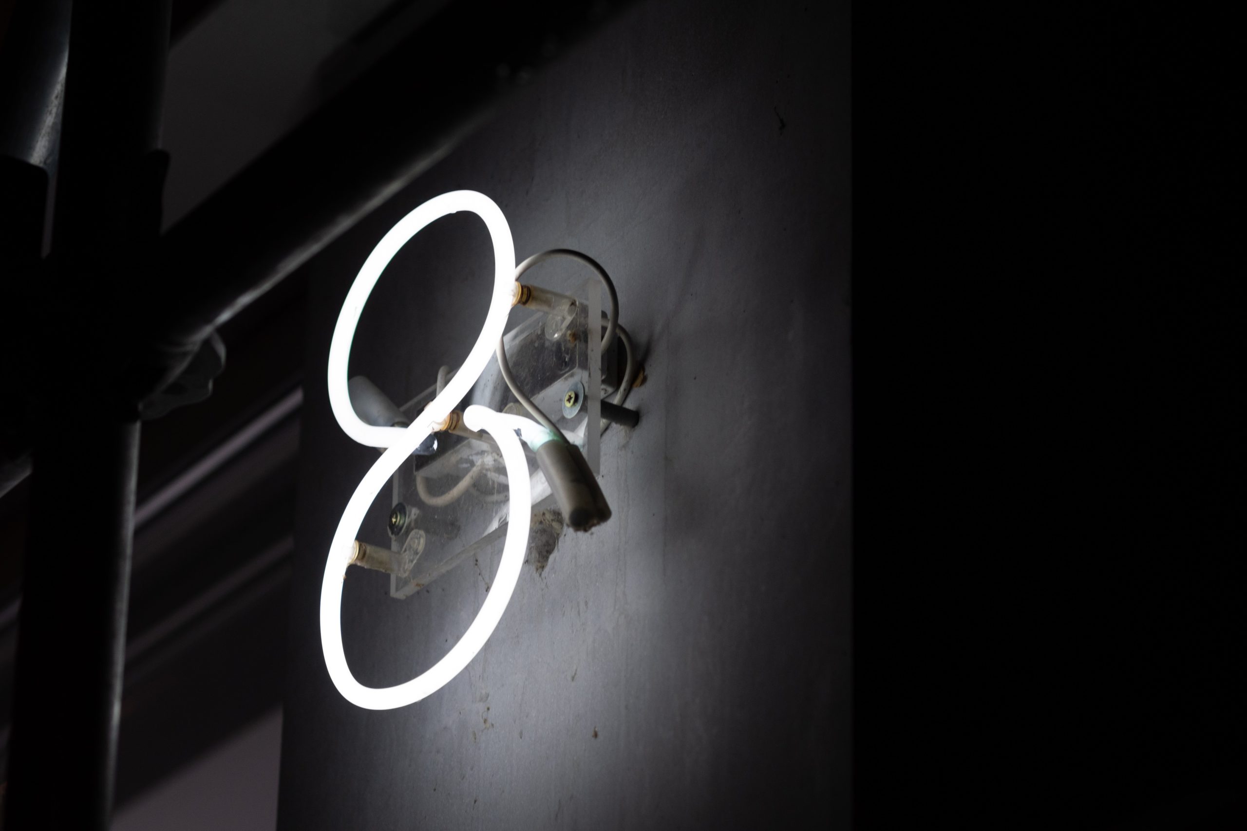 Neon number 8 mounted on wall