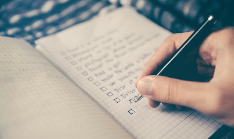 close up of pen writing in notebook