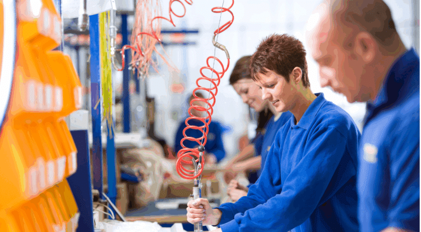 3 workers emsambling products on a factory.